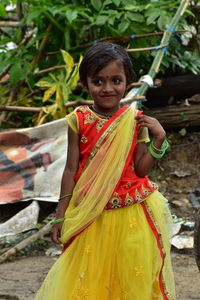 Portrait of smiling girl standing outdoors