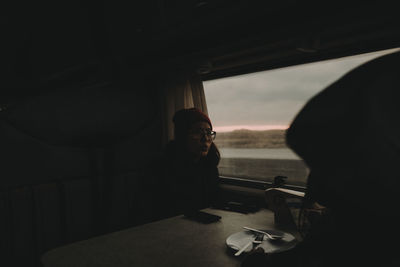 Woman traveling in train during sunset