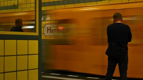 Rear view of man on train at railroad station