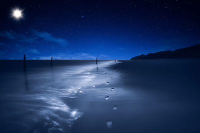 Scenic view of sea against sky at night