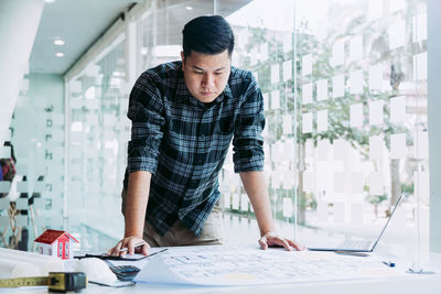 Portrait of young man working at office