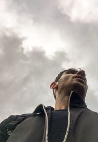 Low angle view of man looking against sky