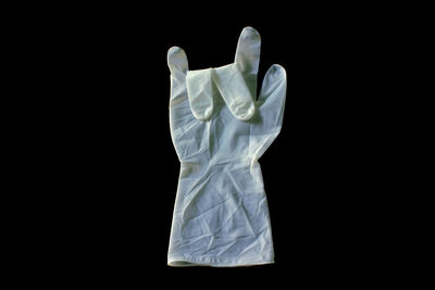 Close up of surgical glove on black background