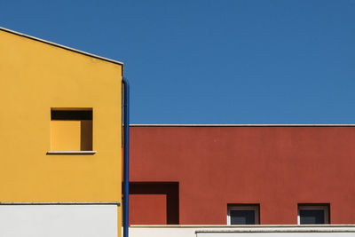 Low angle view of yellow building against clear sky