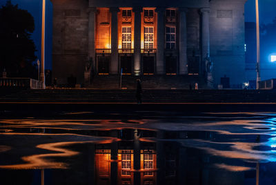 Reflection of building in city at night