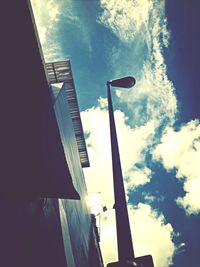 Low angle view of building against cloudy sky