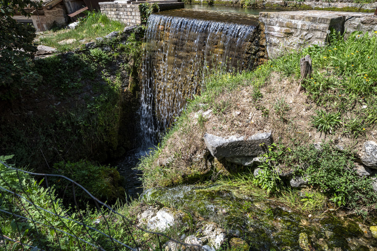 plant, nature, no people, day, architecture, growth, water, high angle view, grass, built structure, outdoors, green, garden, pond, tree, stream, land, sunlight, waterway, tranquility, ruins, beauty in nature, rock, wall, history