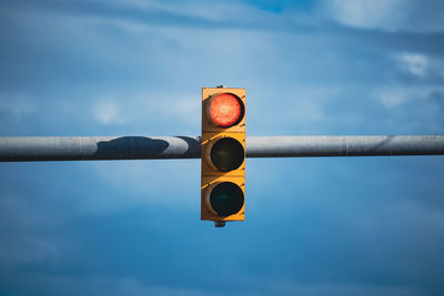 Low angle view of road sign against sky