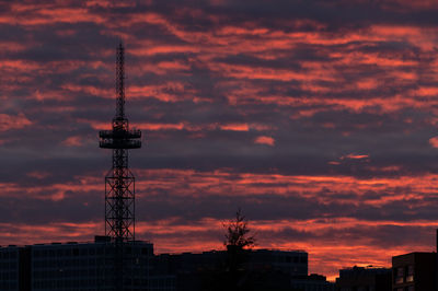 Low angle view of silhouette buildings against dramatic sky