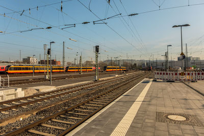 Train at railroad station against clear sky