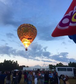 Low angle view of people against cloudy sky