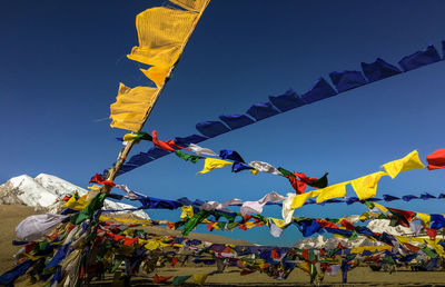 Praying flags hanging against sky