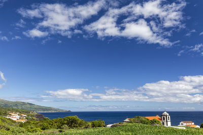 Scenic view of sea and buildings against sky