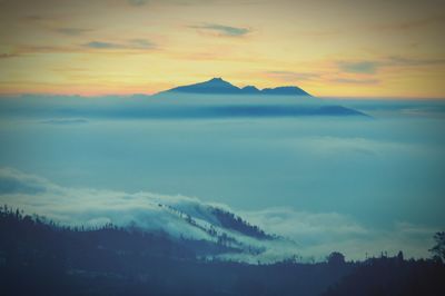 Scenic view of mountains against sky during sunset