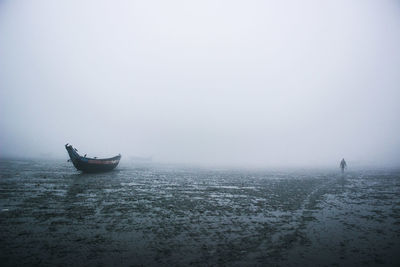 Boat on shore in foggy weather