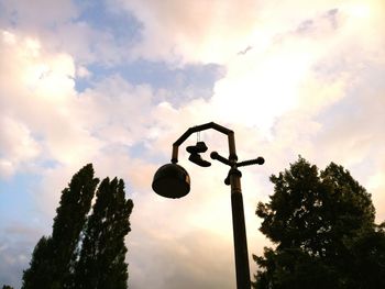 Low angle view of street light against cloudy sky