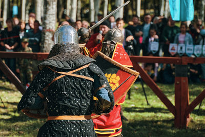 Rear view of people on field