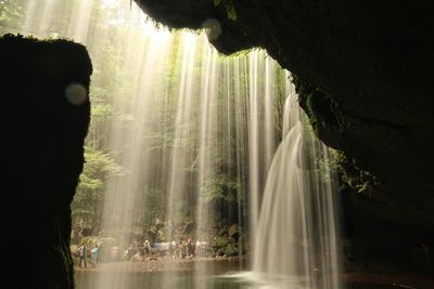 Scenic view of waterfall against sky