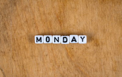 Close-up of text written on wooden surface