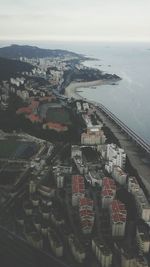 Aerial view of cityscape by sea against sky