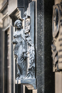 Close-up of statue against building