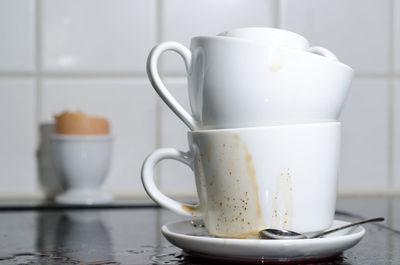 Close-up of coffee cups on table