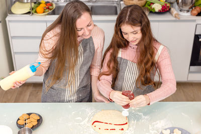 Women in traditional clothing at home