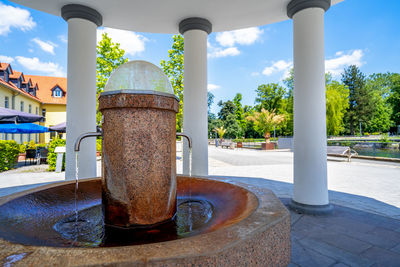 Close-up of fountain in swimming pool against building