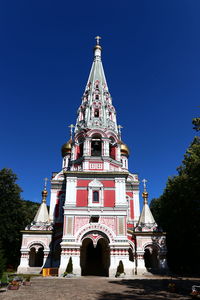 Low angle view of temple building against clear blue sky