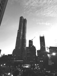 Low angle view of illuminated buildings against sky in city