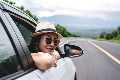 Portrait of man wearing sunglasses on road