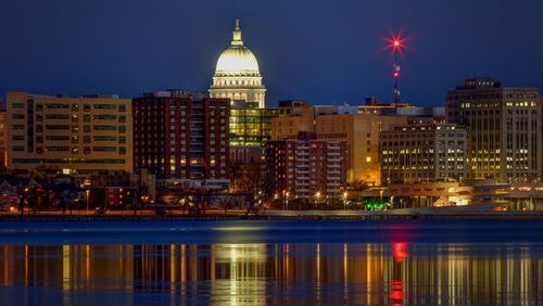 Reflection of illuminated buildings in city at night