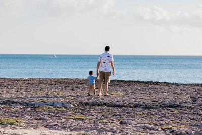 Father and son on a beach bonding