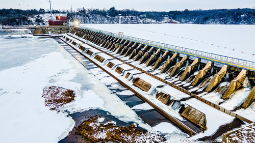 Frozen river with cold walkway at top of the dam.