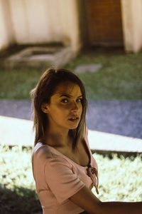 Portrait of young woman standing outdoors