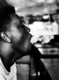 Close-up of young man smoking cigarette