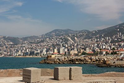 Buildings in city against cloudy sky