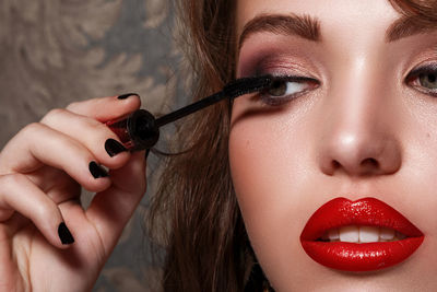 Close-up of woman applying mascara