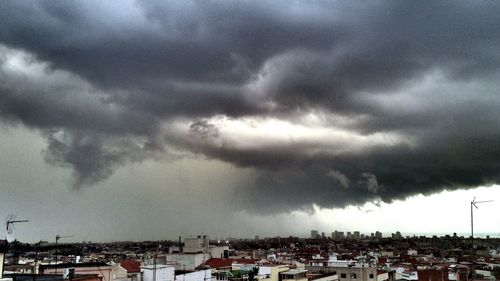 Cityscape against cloudy sky