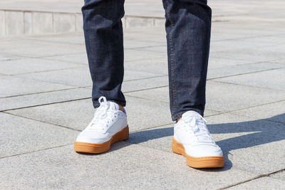 Low section of man standing on footpath