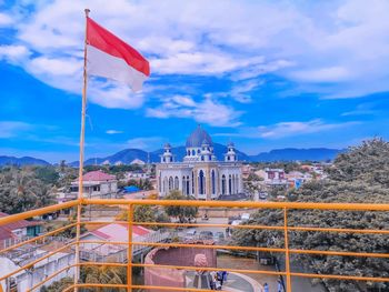 Low angle view of flag on building against sky