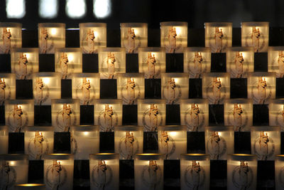 Full frame shot of illuminated candles in temple