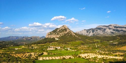 Scenic view of landscape and mountains against blue sky