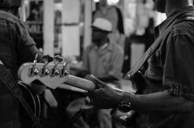 Close-up of man playing guitar