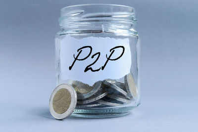 Close-up of coins on glass against white background