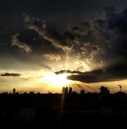 Silhouette cityscape against sky during sunset