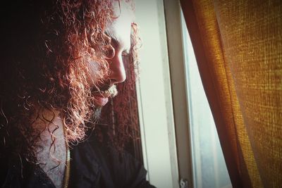 Close-up of woman looking at window