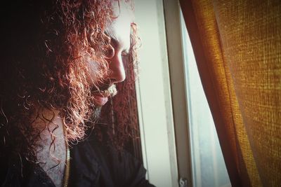 Close-up of woman looking at window