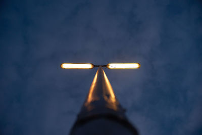 Low angle view of illuminated lamp against sky at night