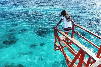 High angle view of woman standing in sea